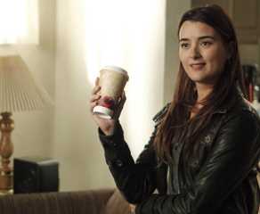 Cote de Pablo as Ziva David grins holding a coffee cup in NCIS