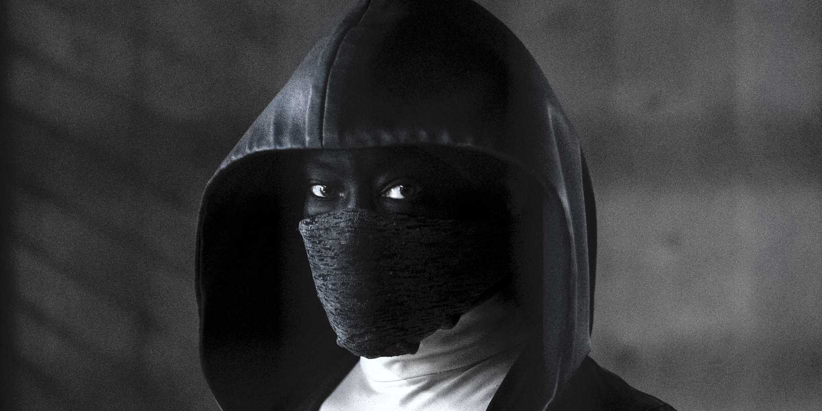 Regina King as Sister Night dressed all in black in Watchmen