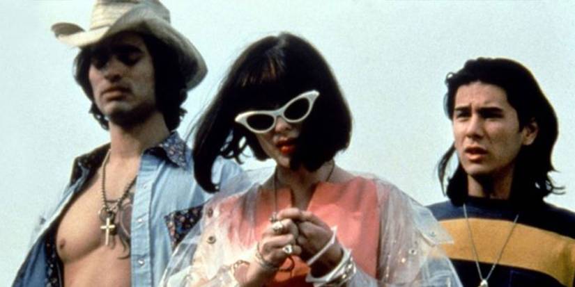 Three people stand against a grey sky in The Doom Generation