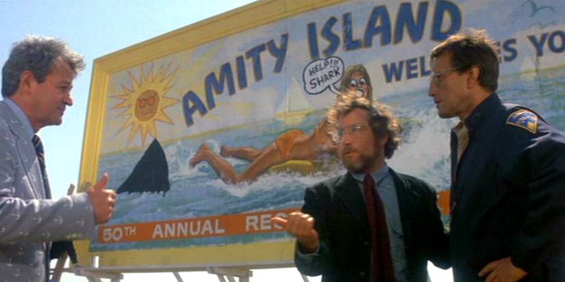 People talk by the Amity Island sign