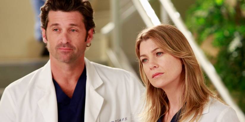 Derek and Meredith standing together looking concerned on Grey's Anatomy.