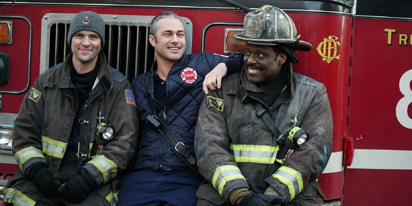 Three firefighters sit on the truck in Chicago Fire