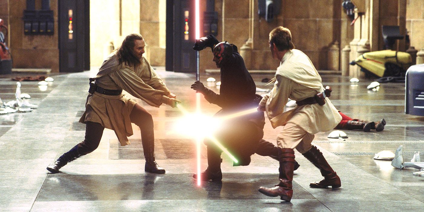 Qui-Gon Jinn and Obi-Wan Kenobi cross sabers while dueling Darth Maul in Star Wars: Episode I - The Phantom Menace