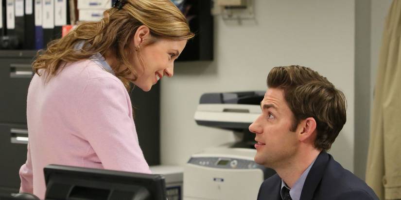 Jim kneeling to talk to a smiling Pam in The Office season 9