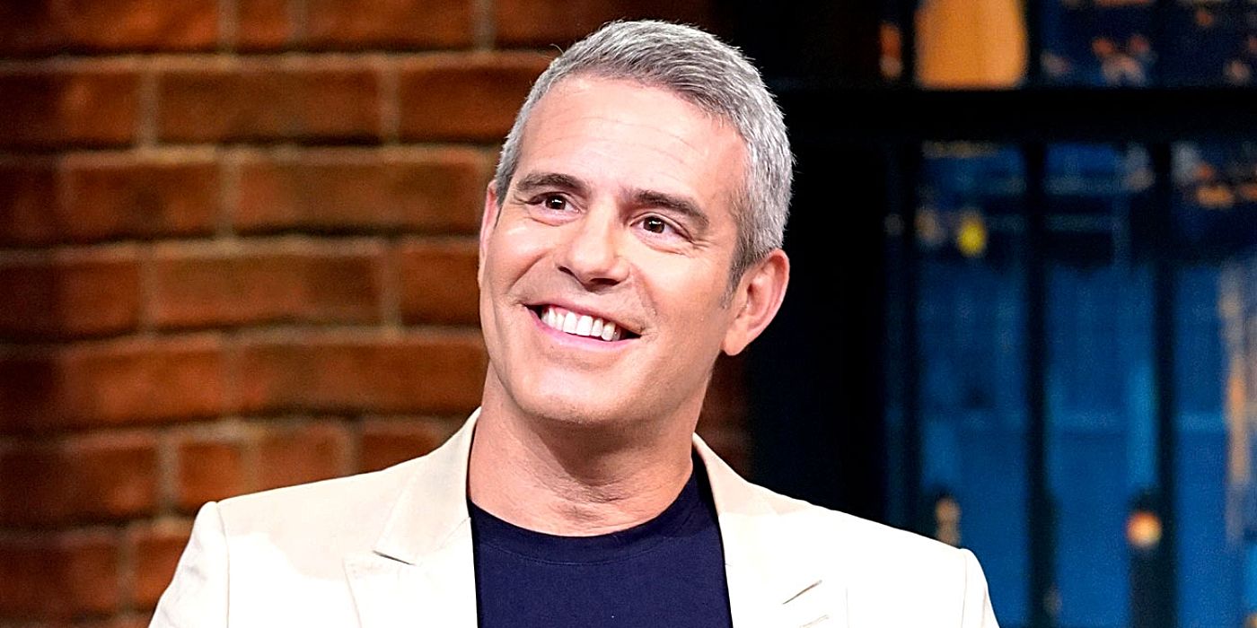 Andy Cohen from Watch What Happens Live smiling while taking  a headshot in the studio