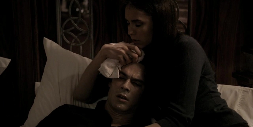 Elena comforts a dying Damon in The Vampire Diaries