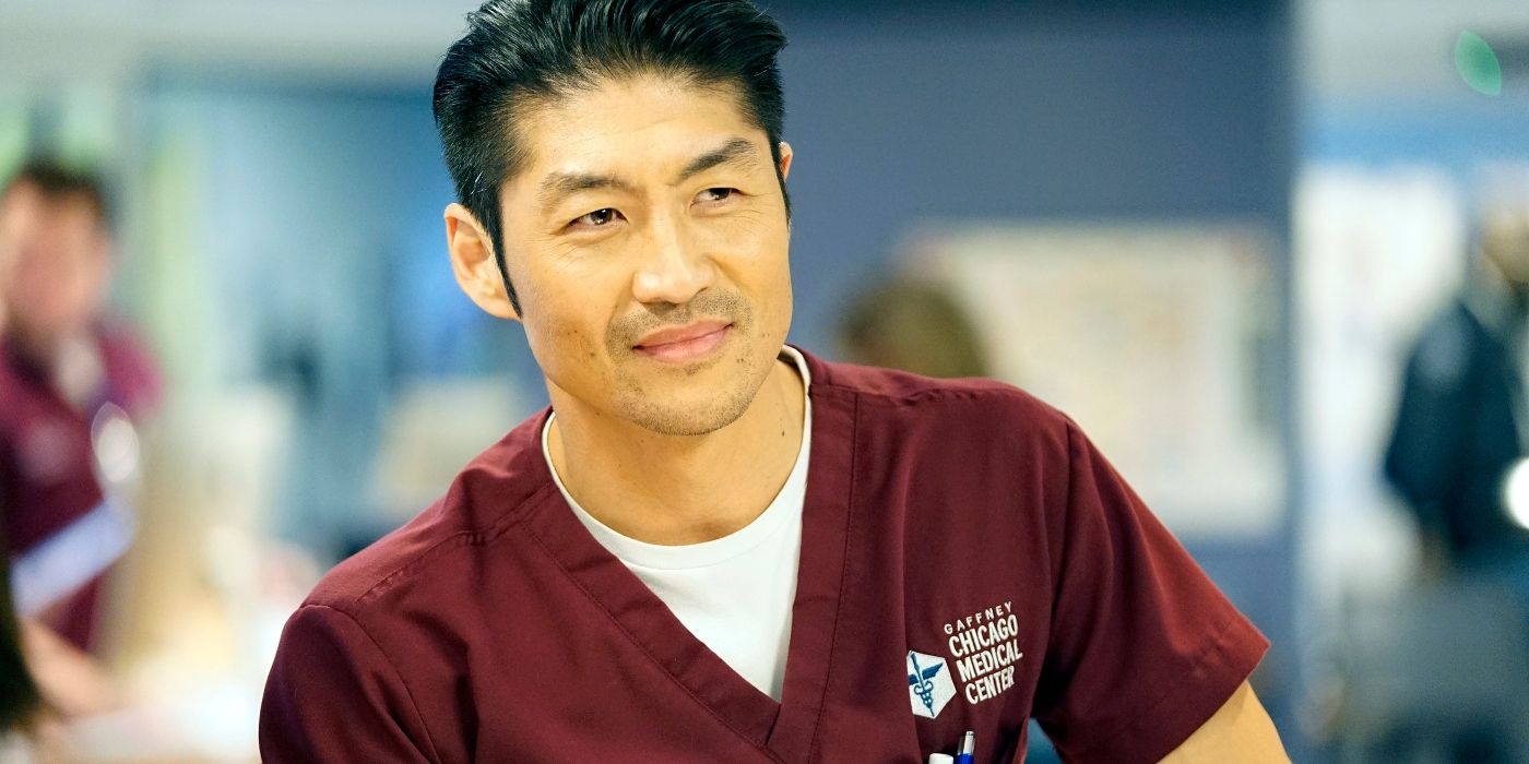 Ethan Choi smiling at something off screen while wearing his maroon scrubs in Chicago Med 