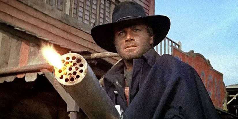 franco Nero firing a mini-gun in Django