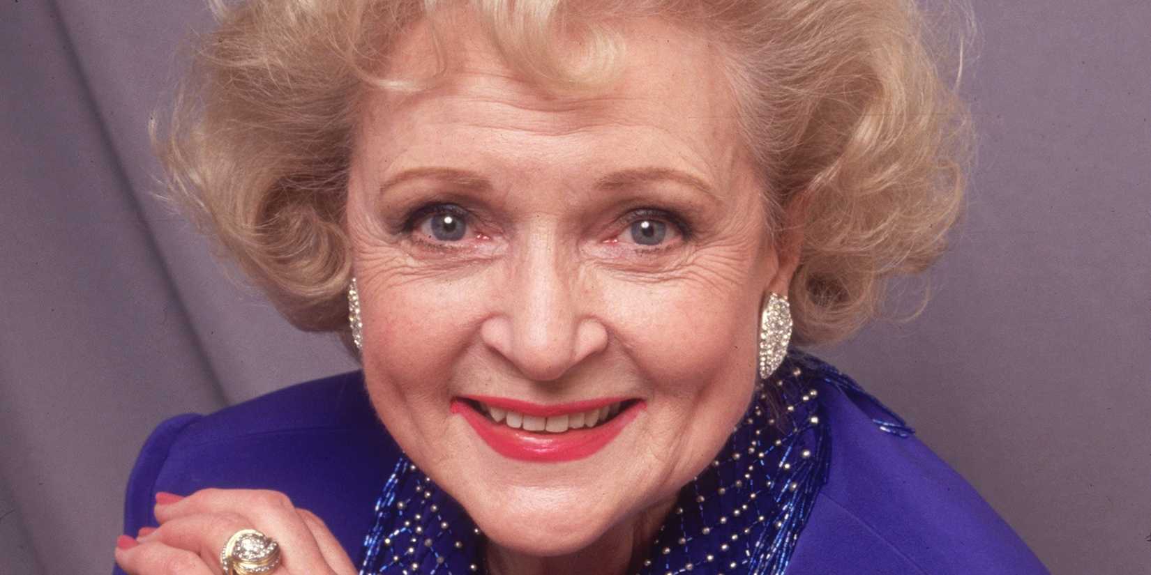 A closeup of Betty White smiling as Rose Nyland in a promotional picture for Golden Girls