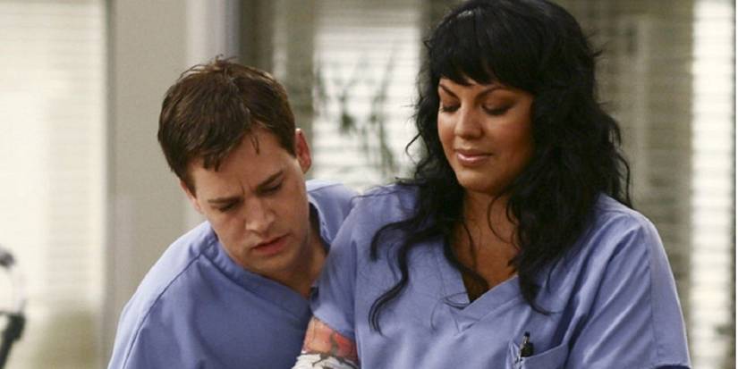 George and Callie wearing blue scrubs at the hospital on Grey's Anatomy