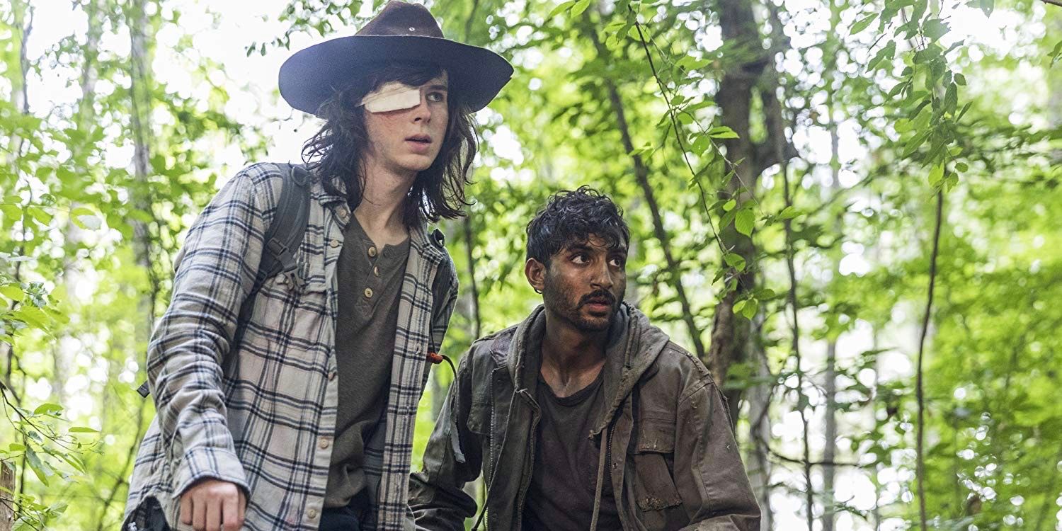 Chandler Riggs as Carl Grimes and Avi Nash as Siddiq hiding in the forest in The Walking Dead