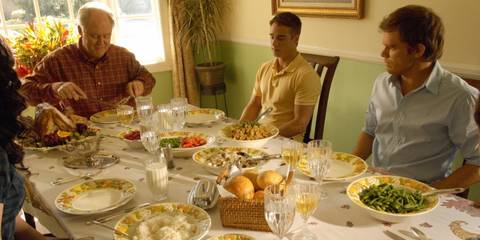 Michael C Hall as Dexter and John Lithgow as Arthur Mitchell sitting at a dinner table in Dexter