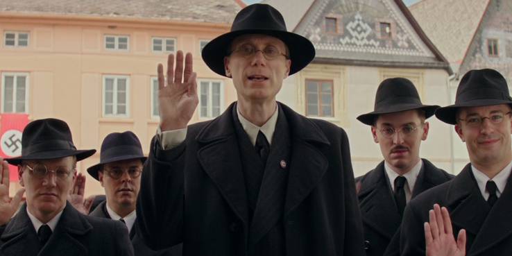 Stephen Merchant (Captain Deertz) arrive at the Betzler home for a surprise search.