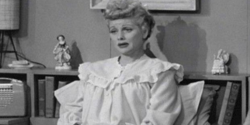 Lucy sitting in her own bed, unable to sleep.