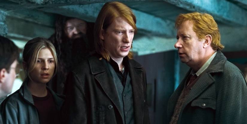 Bill Weasley talking to Arthur with Fleur and Hagrid stood nearby in Harry Potter