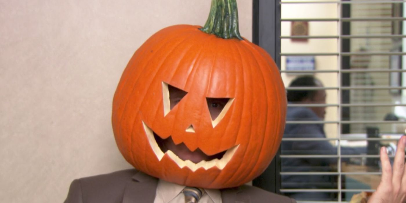 Dwight wearing a pumpkin on his head in The Office