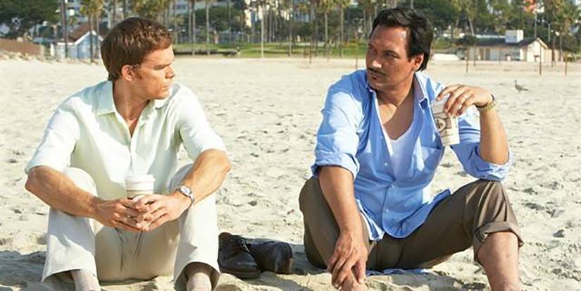 Dexter sits on the beach with Miguel Prado