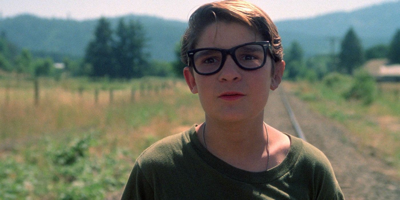 Teddy (Corey Feldman) looking slightly scared in an open field in Stand by Me