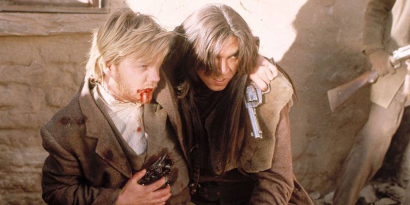 Lou Diamond Phillips hangs on to injured Kiefer Sutherland in Young Guns 2