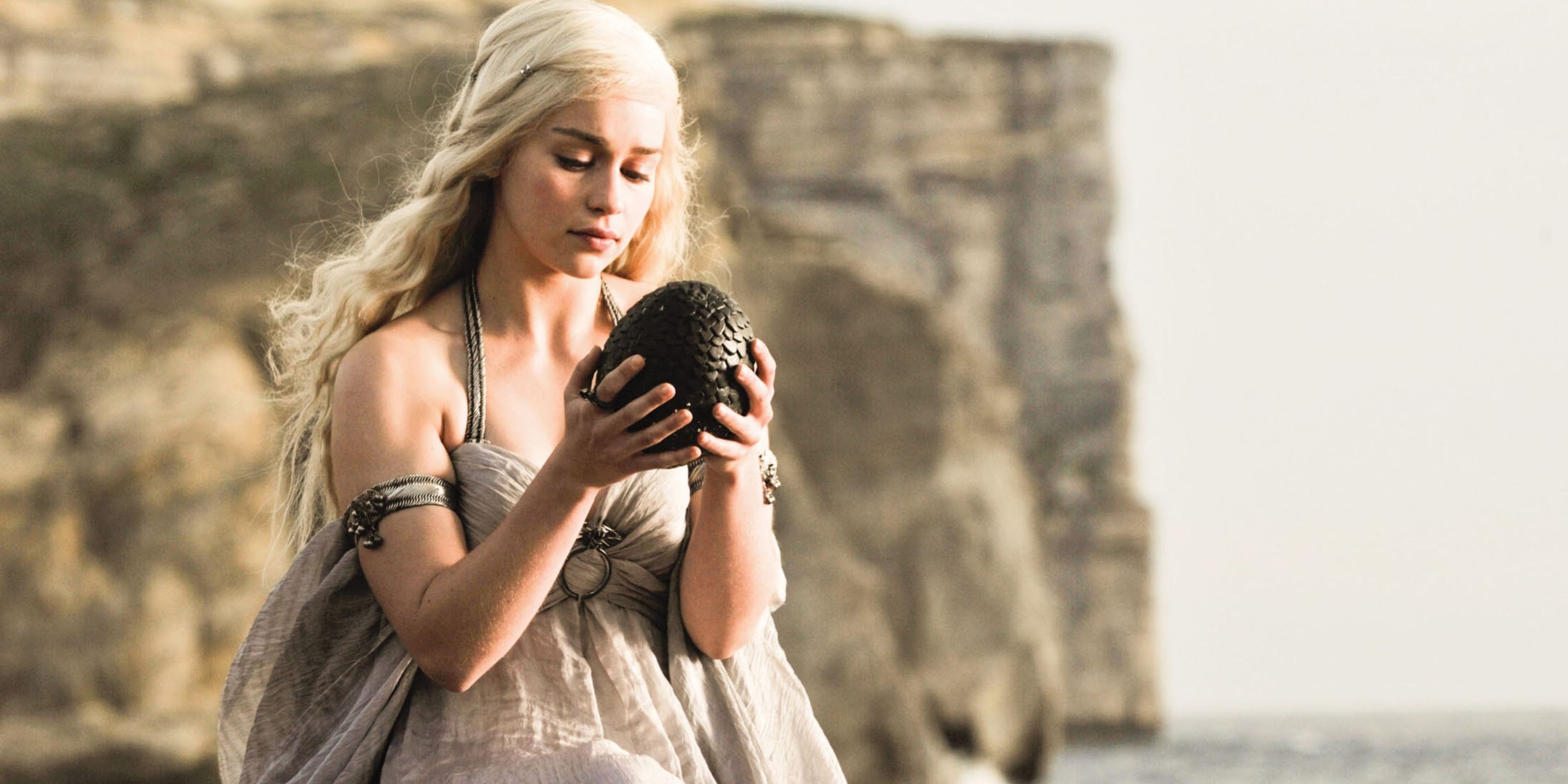 Daenerys Targaryen holding a dragon egg in Game of Thrones season 1