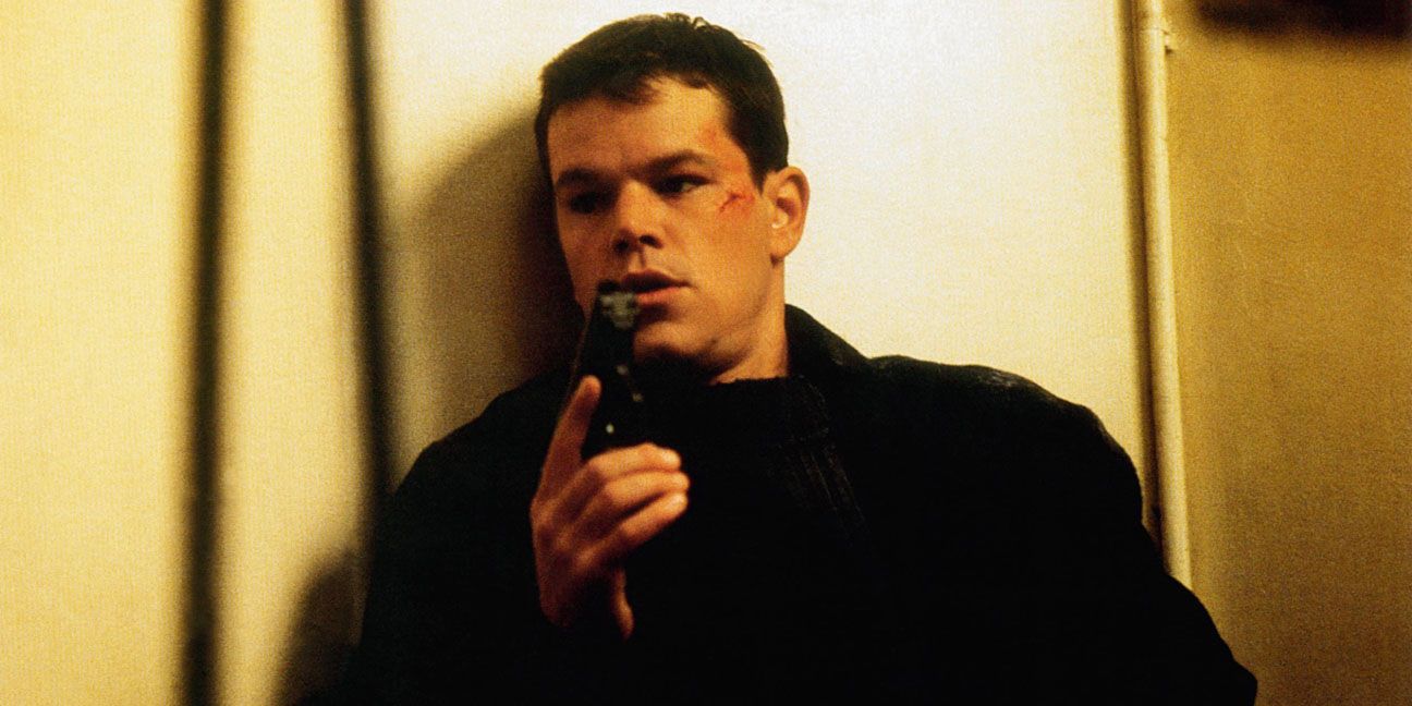Matt Damon holding a gun in The Bourne Identity