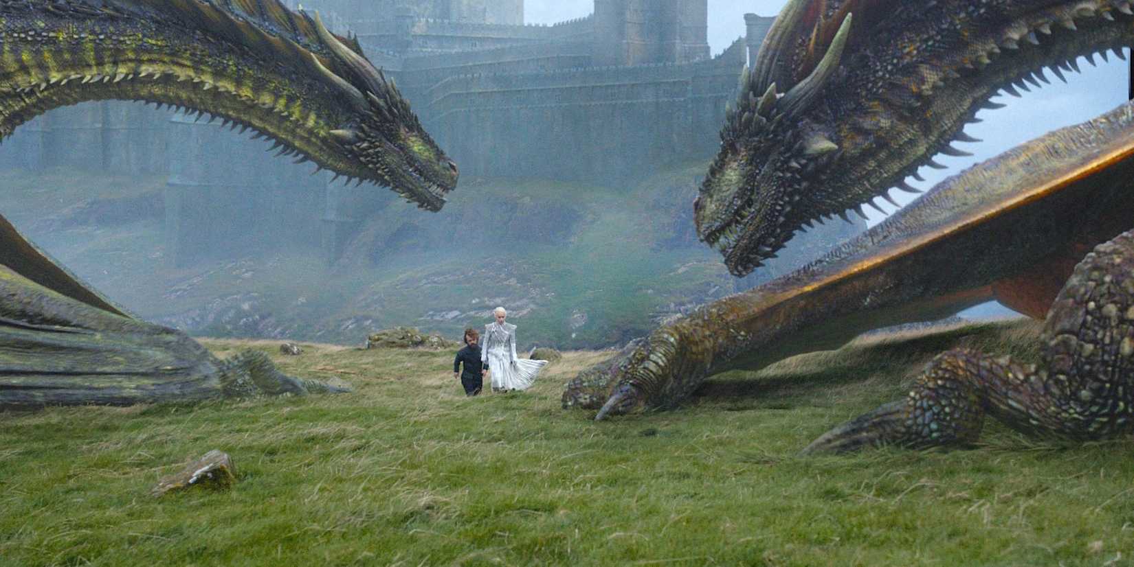 Daenerys Targaryen (Emilia Clarke) and Tyrion Lannister (Peter Dinklage) walking by Rhaegal and Viserion in Game of Thrones