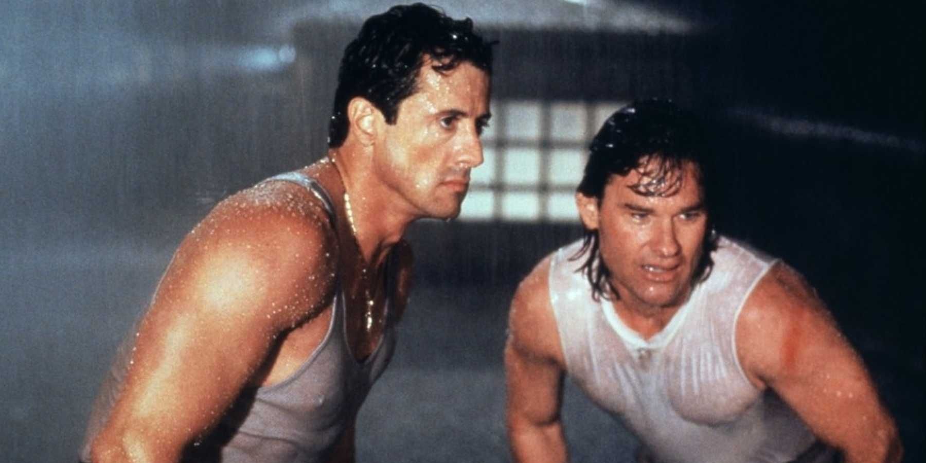 Sylvester Stallone and Kurt Russell as Tango and Cash in the rain and staring off to the side