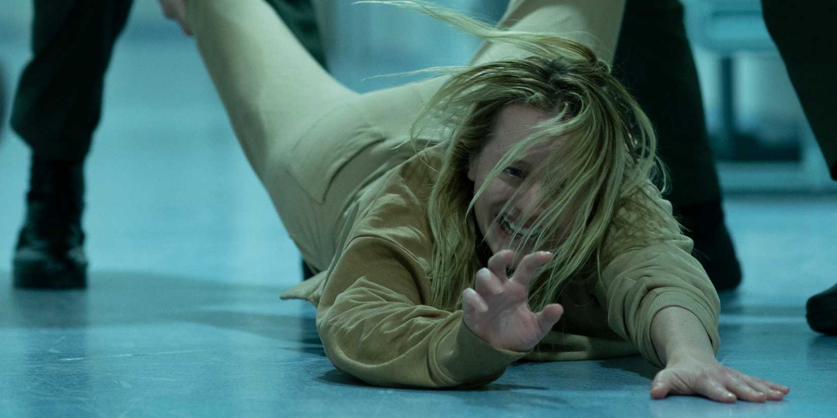 Cecelia is dragged down a hospital hallway in The Invisible Man