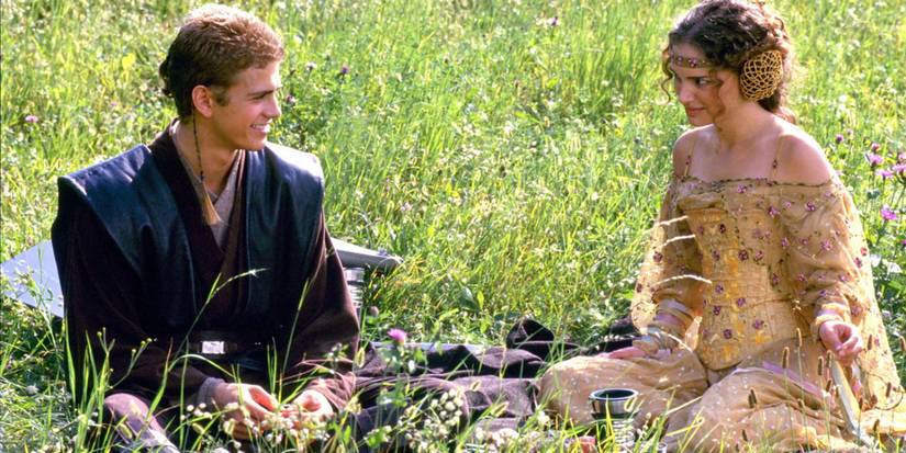 Anakin Skywalker and Padme Amidala in Attack of the Clones sit in a meadow talking and smiling at one another