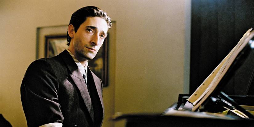 Adrien Brody as Władysław Szpilman seated at a piano in The Pianist