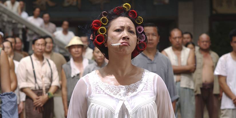 Qiu Yuen looks on angrily with a cigarette in her mouth and curlers in her hair in Kung Fu Hustle