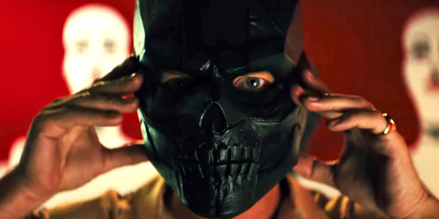 Ronan Sionis holding up his black skull mask in Birds of Prey