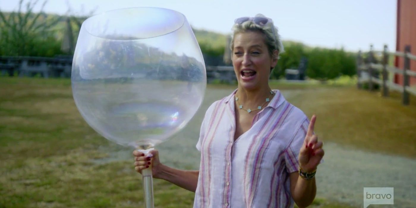 Dorinda standing outside with a giant Wine Glass