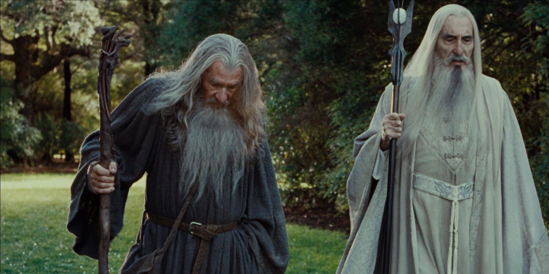 Christopher Lee as Saruman walks with Ian McKellen as Gandalf in Lord of the Rings.