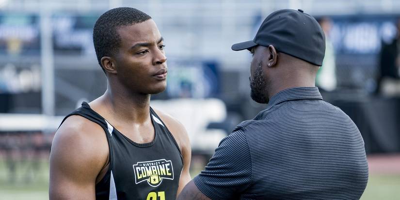 Spencer on the field talking to his coach in All American.