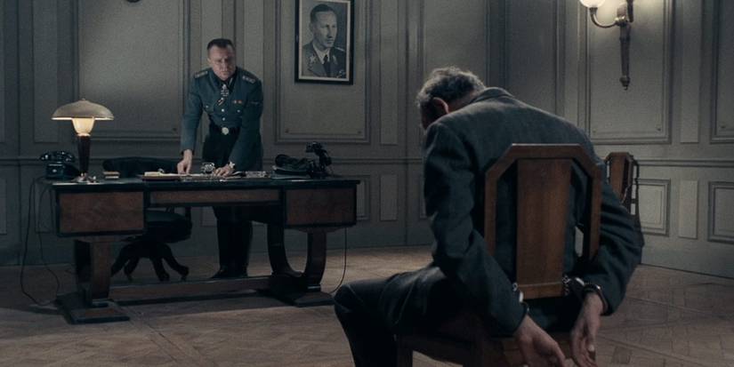 Lino Ventura as Philippe Gerbier, tied to a chair Army of Shadows