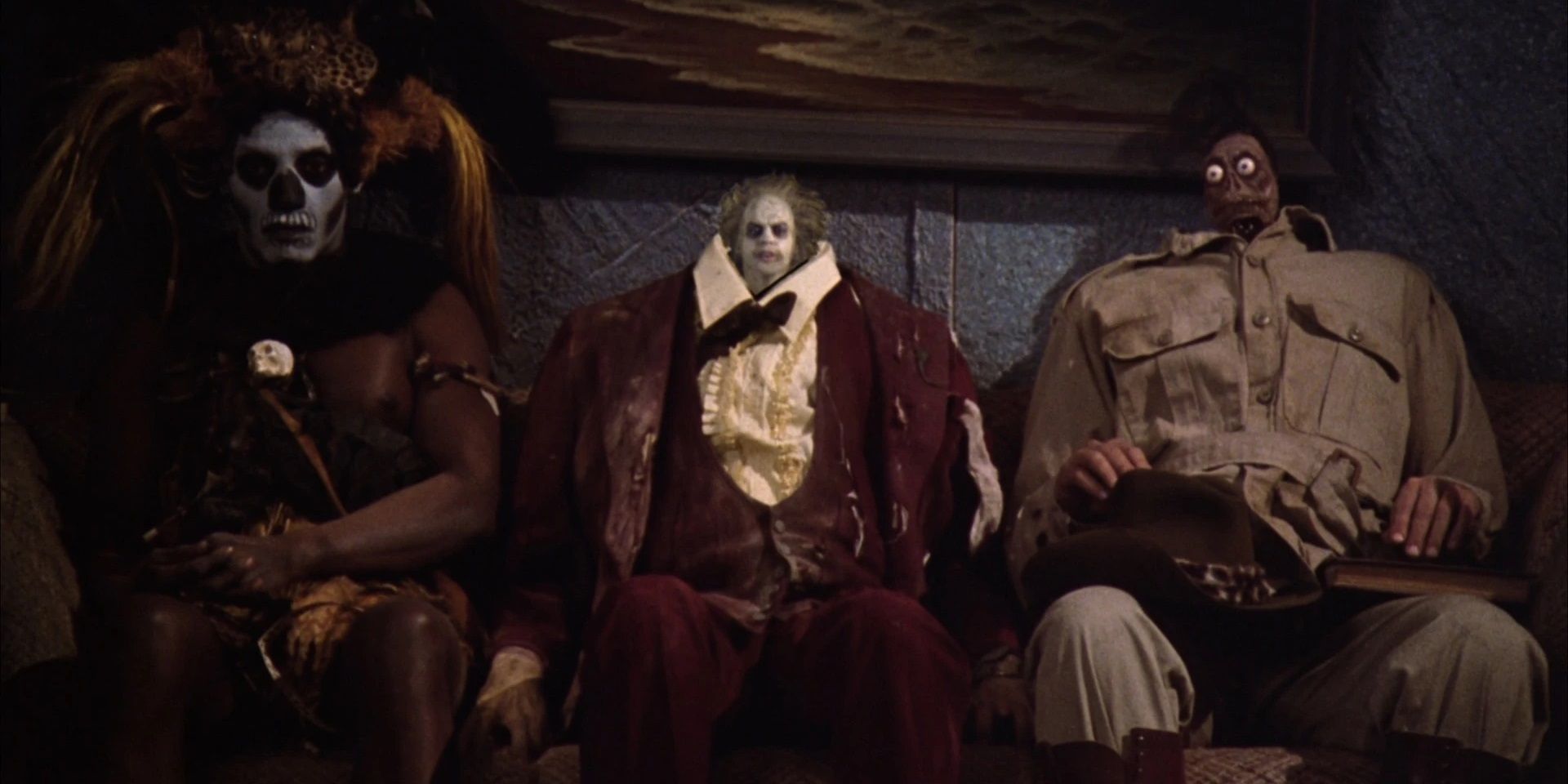 The witch doctor, Beetlejuice, and Harry the Hunter with shrunken heads in Beetlejuice's ending