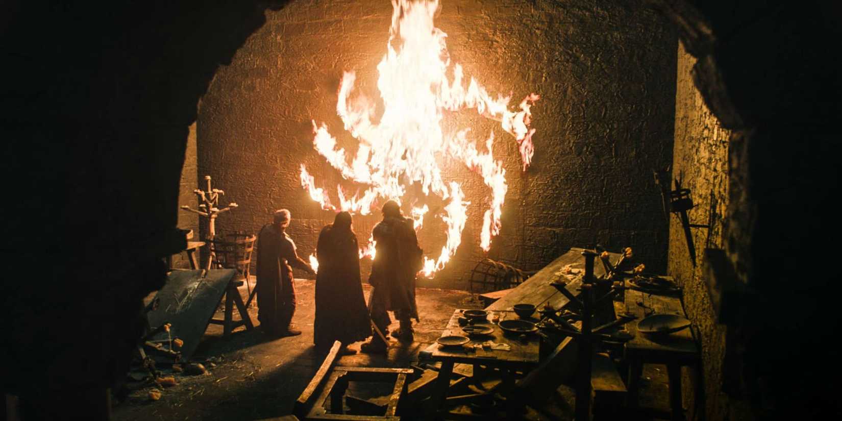 People looking at the flaming White Walker spiral symbol in Game of Thrones