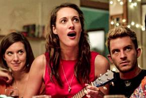Lulu plays the ukulele with Kate and Sam standing behind her in Crashing.