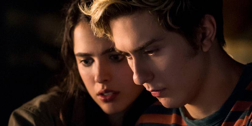 Nat Wolff as Wright and Margaret Qualley as Mia Sutton looking down on something in the movie Death Note
