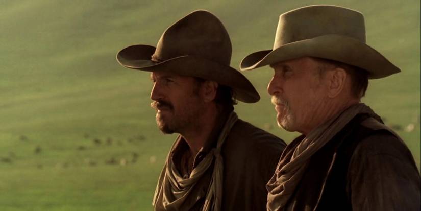Kevin Costner as Charley and Robert Duvall as Spearman looking `at the horizon in Open Range