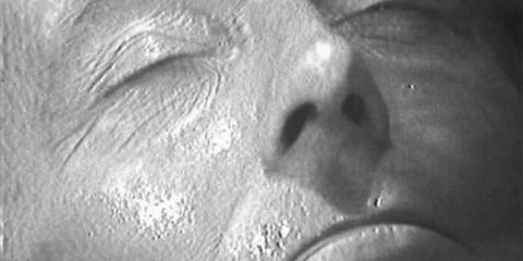 A close up of William Hartnell as the First Doctor regenerating in Doctor Who.