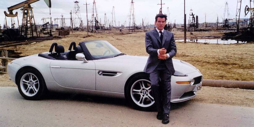 Pierce Brosnan as James Bond in The World is Not Enough, standing in front of a 1999 BMW Z8 car. 