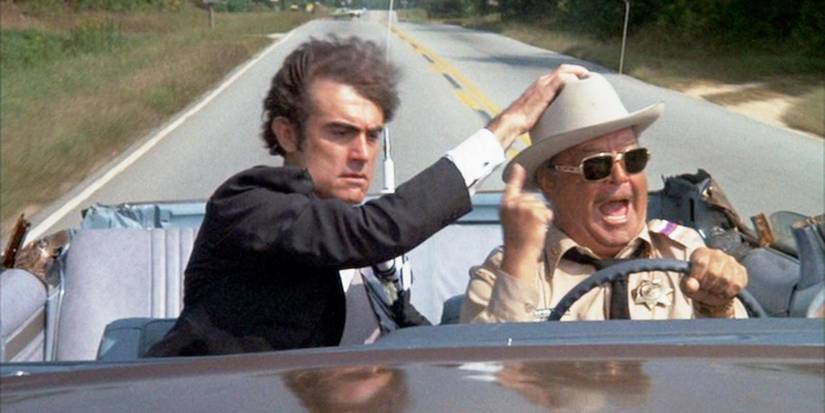 Junior holding Sherrif Buford T. Jutsice's hat in Smokey and the Bandit
