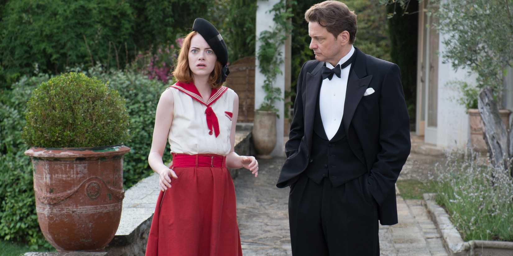 Emma Stone and Colin Firth walking through a garden in Magic in the Moonlight