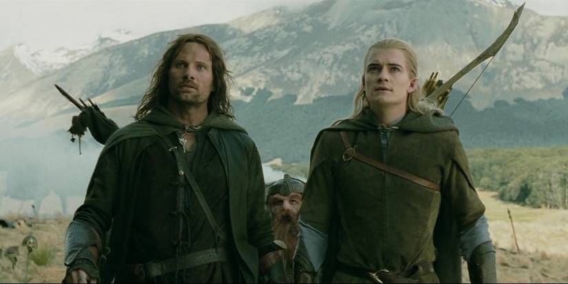Aragorn and Legolas standing next to each other in a field