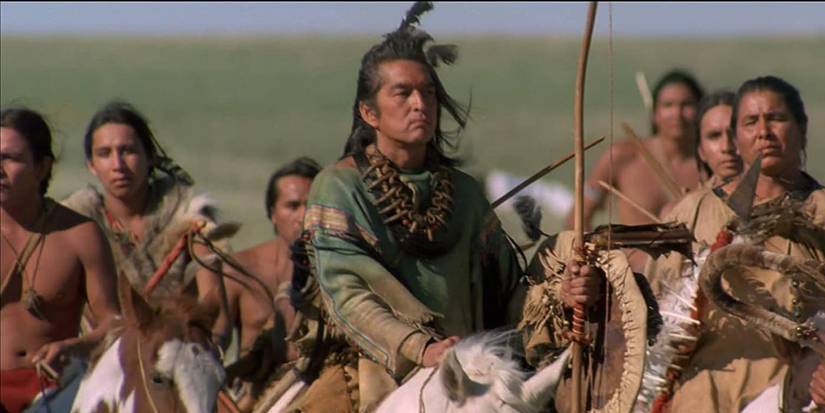 The Lakota nation's people riding horses while holding weapons.