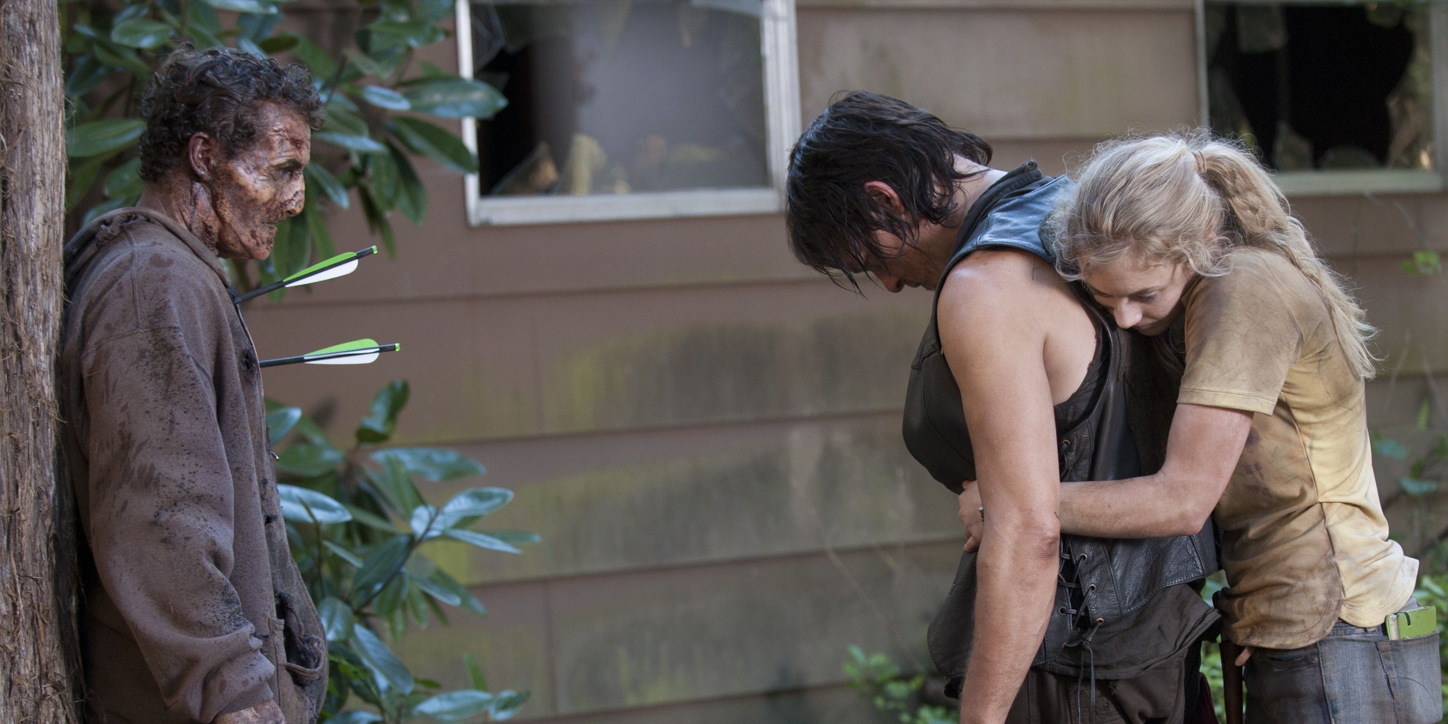 Beth hugs Daryl next to a zombie with two arrows in its chest