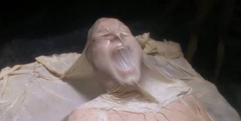 Actor screaming under a thin blanket in Fire in the Sky