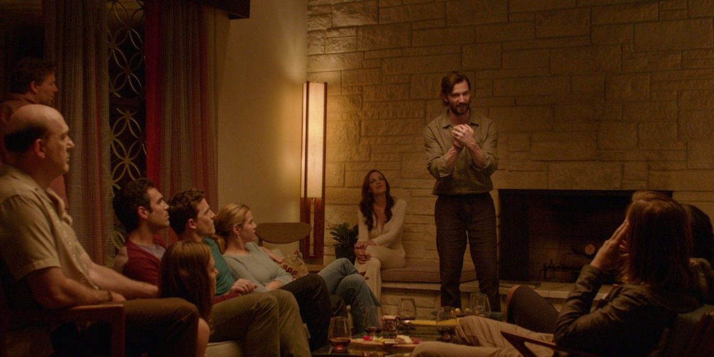 A group of friends sit together in the room in The Invitation